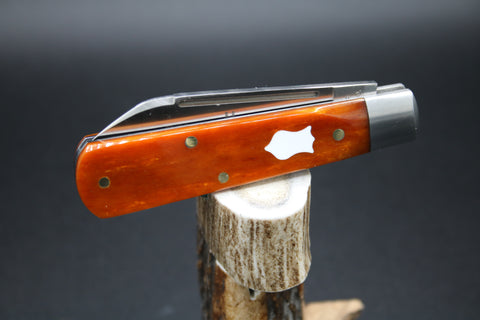 Cooper Cutlery Orange Camel Bone with White Shield Dollar Knife